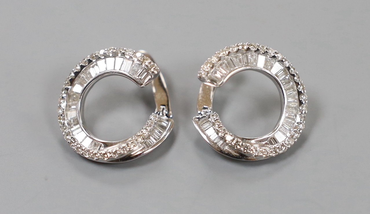 A modern pair of 750 white metal, round brilliant and graduated baguette cut diamond set open work circular earrings, 17mm, gross weight 6.6 grams